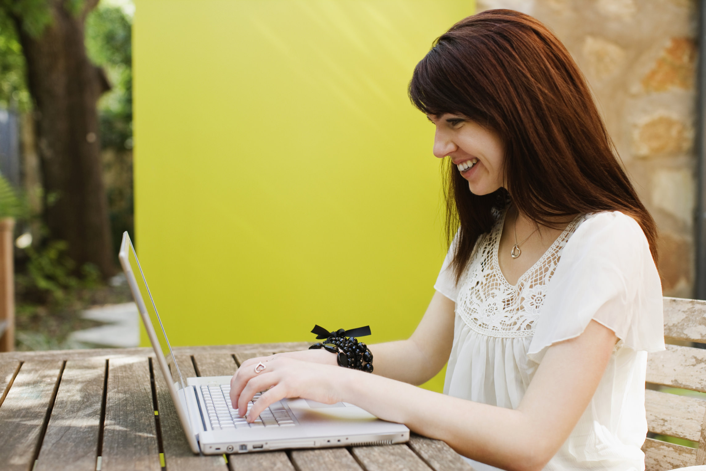 Woman working on a laptop and smiling